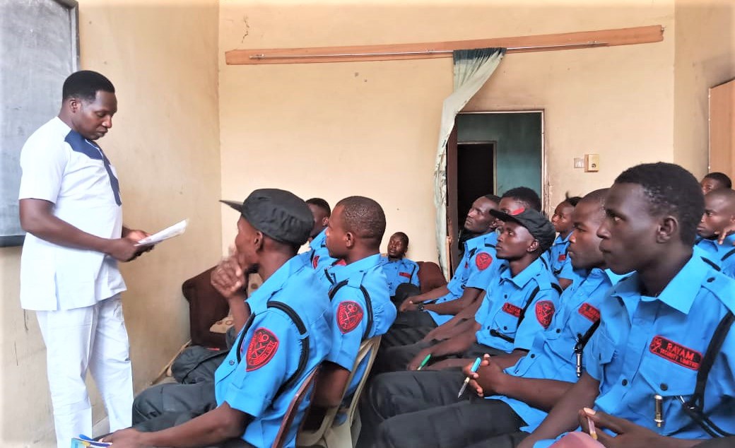 Instructor reading from notes to a class of uniformed Rayam security officers